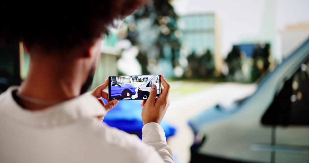 Insurance adjuster taking photos of a car accident after learning the 4 Mistakes to avoid after a car accident.