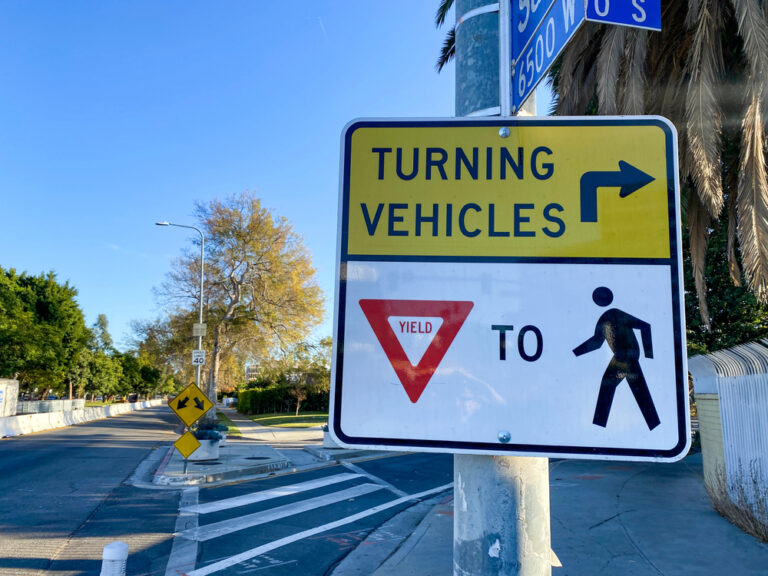 A “yield to Pedestrians” sign to symbolize the 16 questions to ask your pedestrian accident lawyer.