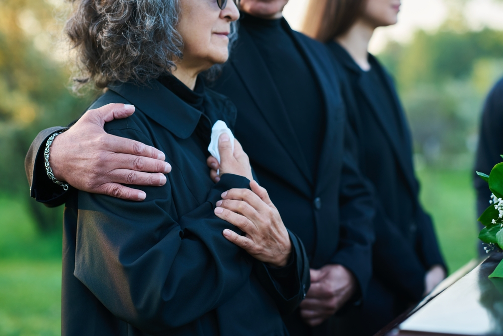 Family members during a funeral service whose loved one just experienced one of the five most common causes of wrongful death.